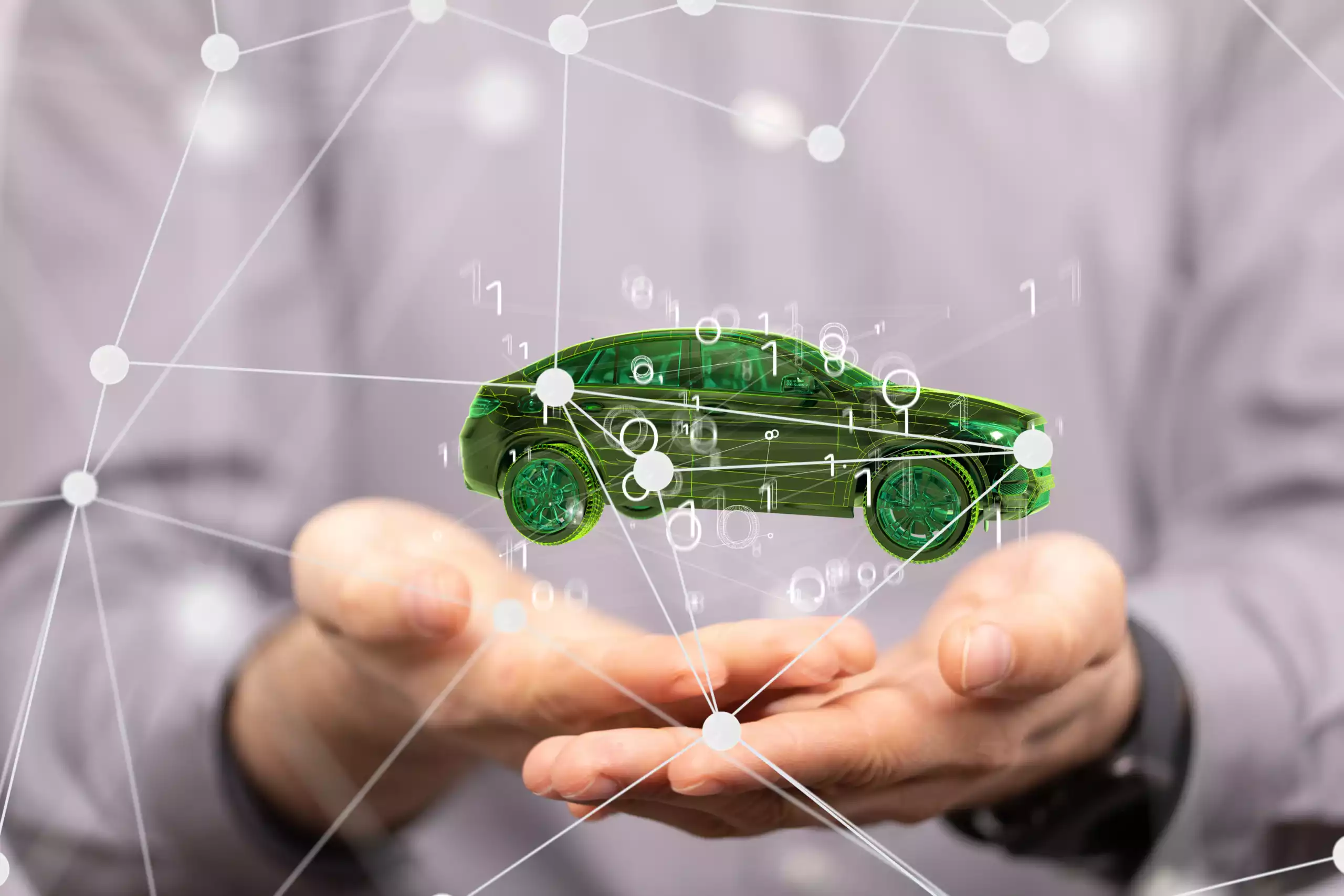 gestion-flotte-connectee-maintenance-predictive-ocean.webp Voiture connectée symbolisée par un hologramme vert dans les mains d’un professionnel, représentant la maintenance prédictive et la gestion de flotte intelligente.